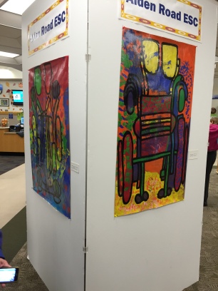 This large column displaying student work is directly ahead upon entering the library!
